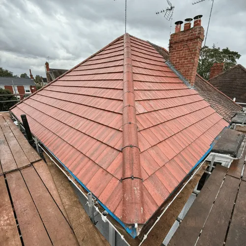 Multiple chimney stacks on traditional slate roof
